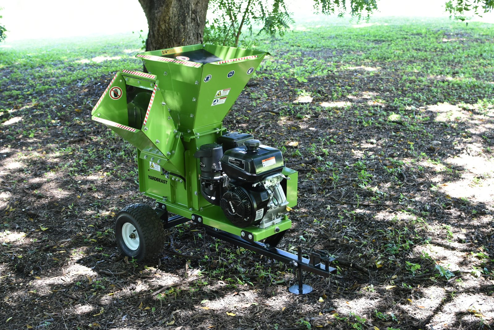 A gas chipper/shredder machine set up in a yard